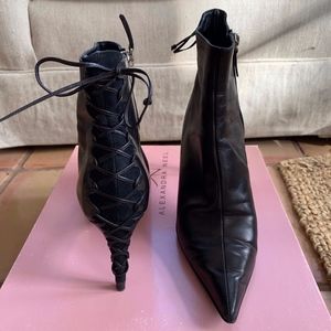 Alexandra Neel High-heeled black bootie with black suede under lace up back tie